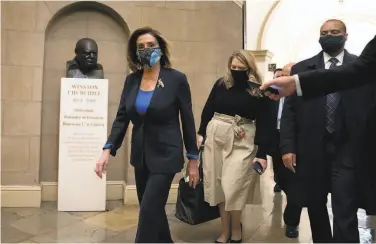  ?? Stefani Reynolds / Getty Images ?? House Speaker Nancy Pelosi ( left) arrives at the Capitol in Washington, D. C. The House approved a resolution calling on Vice President Mike Pence and the Cabinet to invoke the 25th Amendment.