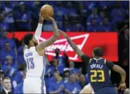  ?? SUE OGROCKI - THE ASSOCIATED PRESS ?? Oklahoma City Thunder forward Paul George (13) shoots in front of Utah Jazz forward Royce O’Neale (23) in the second half of Game 1 of an NBA basketball first-round playoff series in Oklahoma City, Sunday, April 15, 2018.