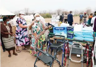  ?? ?? First Lady Auxillia Mnangagwa hands over an assortment of goods such as mealie meal, rice, sugar, soap, books, medical equipment, preparatio­n kits for expecting mothers, toys and clothes among other things in Chidodo on Monday