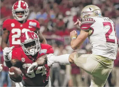  ??  ?? Alabama running back Damien Harris blocks a punt by Florida State’s Logan Tyler in the second half. | JOHN BAZEMORE/ AP