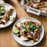  ?? DANIEL J. VAN ACKERE — AMERICA’S TEST KITCHEN VIA AP ?? Chicken Enchiladas are pictured in Brookline, Mass. This recipe appears in the cookbook “The Complete Slow Cooker.”