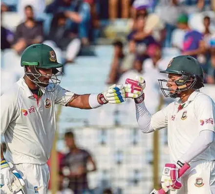  ?? AFP PIC ?? Bangladesh captain Mushfiqur Rahim (right) celebrates with Sabbir Rahman after scoring a half century against Australia yesterday.