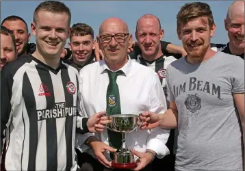  ??  ?? Rosbercon joint captains Joe Meggs and Shane Dwyer accept the Division 4 league trophy from Tom Connor of the Wexford Football League.