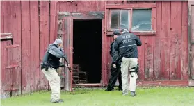  ?? MIKE GROLL/THE ASSOCIATED PRESS ?? State Police officers enter a barn during a search on Sunday in Malone, N.Y. Fugitive David Sweat was shot and captured Sunday.