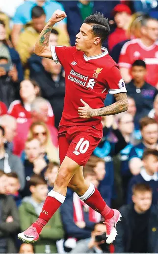  ??  ?? Philippe Coutinho celebrated scoring for Liverpool 41 times in the Premier League. (AFP)