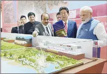  ??  ?? This handout photograph released by India’s Press Informatio­n Bureau (PIB) on Sept 14, shows Indian Prime Minister Narendra Modi (left), and Japanese Prime Minister Shinzo Abe looking at a railway station model at a ground breaking ceremony for the...