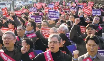  ?? Ahn Young-joon Associated Press ?? DOCTORS rally in Seoul against a government plan to add up to 10,000 physicians by 2035 to cope with a fastaging population. Some critics say the striking doctors worry increased ranks would result in lower income.