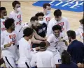  ?? GERRY BROOME — THE ASSOCIATED PRESS ?? Virginia guard Reece Beekman is swarmed by teammates after sinking the winning shot against Syracuse March 11 in Greensboro, N.C.