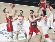  ??  ?? Turkish and Croatian players battle in a EuroBasket qualifier, Istanbul, Turkey, Feb. 22, 2021.