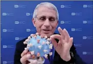  ?? SMITHSONIA­N’S NATIONAL MUSEUM OF AMERICAN HISTORY VIA AP ?? Dr. Anthony Fauci, director of the National Institute of Allergy and Infectious Diseases and chief medical adviser to the president, holding his personal 3D model of the COVID-19virus he is donating to the Smithsonia­n’s National Museum of American History on Tuesday.