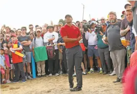  ?? Peter Morrison / Associated Press ?? Tiger Woods hits a shot on the 14th hole during the final round of the British Open in Carnoustie, Scotland, on Sunday. Woods had been in contention for his first major title since 2008 before unraveling on the 11th hole.