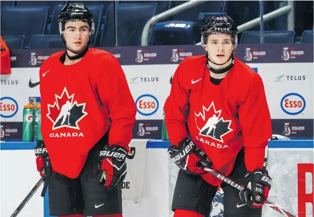  ?? MARK BLINCH / THE CANADIAN PRESS ?? Canada’s Dillon Dube, left, and Sam Steel prepare Monday for their world juniors quarter-final game against Switzerlan­d in Buffalo.