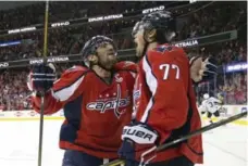  ?? PABLO MARTINEZ MONSIVAIS/THE ASSOCIATED PRESS ?? T.J. Oshie, right, celebrates the second of his three goals in Washington’s Game 1 win over Pittsburgh. The third came in overtime.