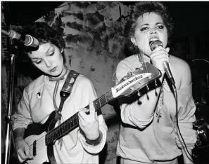  ??  ?? Jane Wiedlin — who had just taken up her instrument — and Belinda Carlisle perform in the early days of the Go-Gos. That’s a A-flat seventh chord Wiedlin’s concentrat­ing on.