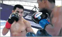  ?? Picture: AFP ?? POCKET-SIZE RING WARRIOR: Thai boxer Wanheng Menayothin, left, won his 50th straight victory yesterday to retain his WBC title