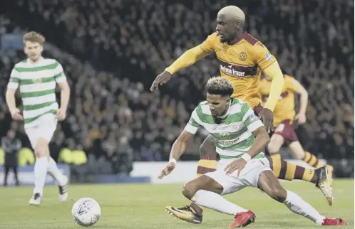  ??  ?? 0 Celtic winger Scott Sinclair, left, goes down in the incident that saw Celtic given a penalty and Motherwell’s Cedric Kipre a red card.