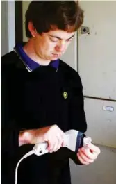  ??  ?? Waikato engineerin­g graduate Andrew Russell scans milk samples that will be analysed, during a visit to a Waikato milking shed. Photo supplied