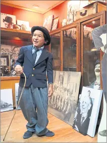  ??  ?? Julan Silva strolls through the Essany Silent Film Museum before taking part in a Charlie Chaplin look-alike contest.
