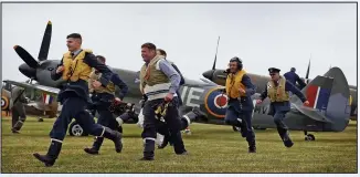  ??  ?? Scramble: Re-enactors in RAF uniform run for their aircraft at Biggin Hill