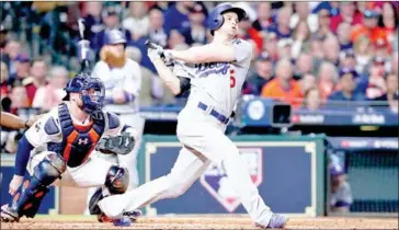  ?? TOM PENNINGTON/GETTY IMAGES/AFP ?? Corey Seager of the Los Angeles Dodgers hits a single during the ninth inning against the Houston Astros in Game 4 of the 2017 World Series on Saturday in Houston, Texas.