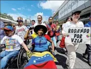  ?? FEDERICO PARRA/GETTY-AFP ?? Opposition supporters protest the slow pace of a recall measure Wednesday in Caracas, the Venezuelan capital.