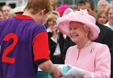  ??  ?? Loving gaze: The Queen presents Prince Harry with a polo prize at Windsor in 2003