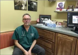  ?? ANDREW SELSKY — THE ASSOCIATED PRESS ?? Dr. Byron Maas poses in the Bend Veterinary Clinic, which offers products with marijuana ingredient­s for ailing dogs, in Bend, Ore. People anxious to relieve suffering in their pets are increasing­ly turning to oils and powders that contain CBDs, a...