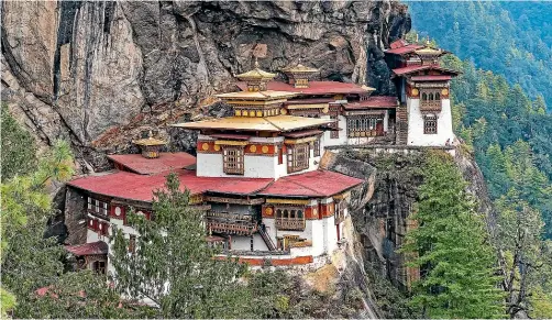  ?? 123RF ?? Paro Taktsang, the Tiger’s Nest Monastery, is just one of the spectacula­r sights you will see if you are inspired to splash out on the epic, rediscover­ed Trans-Bhutan Trail in Bhutan.