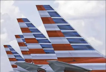  ?? Alan Diaz/Associated Press ?? The tails of four American Airlines passenger planes in 2015.