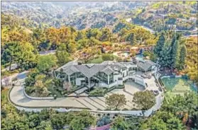  ??  ?? SET ON four acres in the Beverly Hills Post Office area, the glass mansion dazzles with pyramid skylights and angled walls.