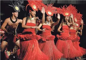  ?? RONEN ZILBERMAN/AP ?? Polynesian Cultural Center dancers perform during the concert/luau for the Honolulu Marathon in Waikiki.