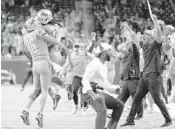  ?? PAUL SANCYA/AP ?? The Lions celebrate after beating the Vikings 29-27 with a TD on the final play Sunday in Detroit.