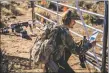  ?? ?? Left: Paul ‘Pecos’ Gonzales reads instructio­ns during a blind stage on Saturday (March 26) during a shoot match at Shoot ‘em’ Up Taos. RIght: Santiago Tafoya, right, and Matthew Chavez scan the range for targets during a hunter-style match.