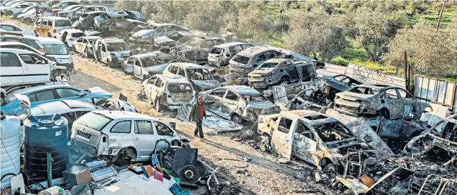  ?? ?? The destructio­n in Huwara, near Nablus, yesterday after Israeli settlers on the West Bank rioted overnight, torching cars, homes and shops in revenge for an earlier terror attack