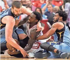  ?? AP ?? Rockets guard Patrick Beverley, center, fights for the ball with Grizzlies center Marc Gasol, left, and guard Mike Conley in the second half on Saturday in Houston.