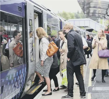  ??  ?? 0 Passengers board their train at Falkirk. All across Scotland Smartcard users have had difficulti­es