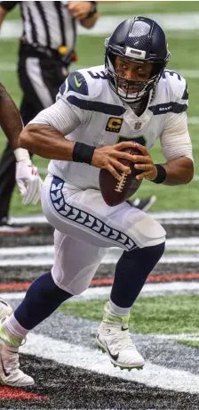  ?? ap FiLe pHOTOS ?? NEW POSITION: Patriots defensive back Myles Bryant steps on the field for training camp practice on Aug. 30. Bryant played the role of Seahawks quarterbac­k Russell Wilson (right) in practice on Thursday in advance of the Patriots game against Seattle on Sunday.