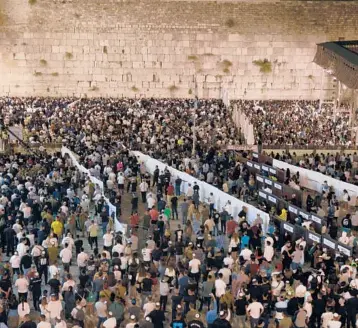  ?? MENAHEM KAHANA/GETTY-AFP ?? Jewish new year: Thousands of Jewish pilgrims attend prayers ahead of Rosh Hashanah at the Western Wall in the Old City of Jerusalem. Religious and secular Israelis alike marked the Jewish new year, which began at sunset Monday and ends Wednesday evening.