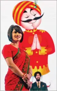  ?? REUTERS ?? An Air India steward poses during the unveiling of their new uniforms at an aviation conference in Mumbai on Tuesday.