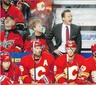  ?? LYLE ASPINALL ?? Calgary Flames coach Glen Gulutzan yells to his players during NHL action last season. Gulutzan is almost certain to see some changes to the roster when the Flames come out of the expansion draft.