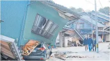  ?? PRESS via AFP JIJI ?? PEOPLE walk past damaged houses in the city of Nanao, Ishikawa Prefecture in Japan, this week, after a 7.6 magnitude earthquake struck the Noto region in Ishikawa prefecture. |