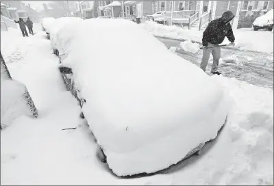  ?? [PETER PEREIRA/(NEW BEDFORD) STANDARD TIMES] ?? Jacob Caban digs out his car along a street in New Bedford, Mass.