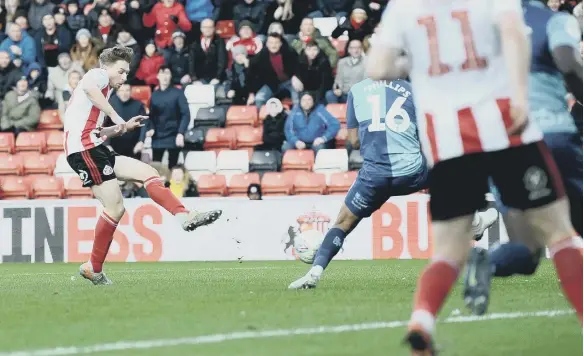  ??  ?? Denver Hume scores against Wycombe Wanderers earlier this season.