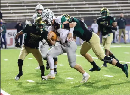  ?? DAVID C. TURBEN — FOR THE NEWS-HERALD ?? Lake Catholic QB Joe Malchesky drags defenders with him to the end zone during the Cougars’ 35-7 Division IV regional final win over Ursuline in Youngstown on Nov. 7.