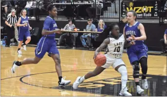  ?? / Lorene Parker ?? Above: The Lady Jackets looked for chances to get ahead of Model, but found the Lady Blue Devil defense tough last Friday, Dec. 15. Left: The Rockmart Lady Jackets struggled to find a way to beat Model, but fell 47-40.