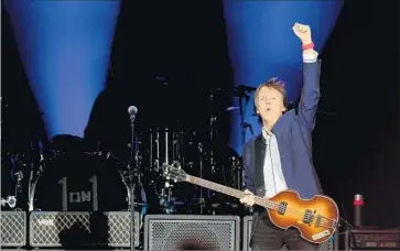  ??  ?? PAUL McCARTNEY takes the stage for his set Saturday, during which he brought out Rihanna for a duet.