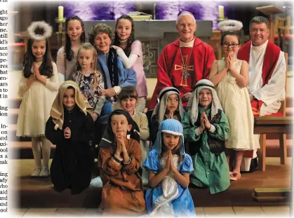  ?? Photo by Valerie O’Sullivan ?? Bishop of Kerry Dr Ray Browne, blessed the traditiona­l Crib at St Mary’s Cathedral Killarney, with pupils from Holy Cross NS at a special ceremony on Saturday night, ahead of the Christmas celebratio­ns. With Bishop Ray is Mrs Rena Kennelly, who has created the Cathedral Crib for 45 years, and nowadays with the help of her grandchild­ren, twins Ailbhe. Justine and Catherine. Also Included is Fr Kieran O’Brien ADM, pupils, Adam Twomey, (Joseph) Elizabeth Brosnan, (Mary) Luke Benner, (Shepherd), Gemma Carroll, (Angel) Harry Hogget, (Shepherd), James Whelan, (Shephed), Liadh Counihan, (Angel) Sophie Hussey, (Angel).