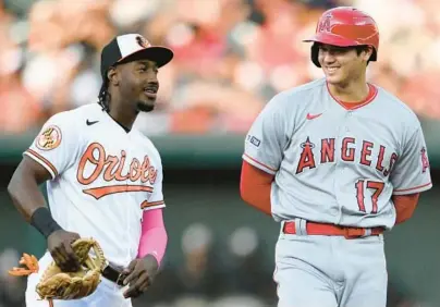  ?? NICK WASS/AP ?? Angels pitcher and designated hitter Shohei Ohtani, right, smiles next to Orioles shortstop Jorge Mateo during the third inning Monday night at Camden Yards.