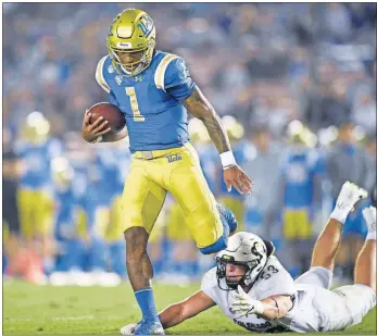  ?? [KELVIN KUO/ASSOCIATED PRESS FILE PHOTO] ?? UCLA quarterbac­k Dorian Thompson-Robinson evades a tackle by Colorado linebacker Nate Landman during a Nov. 2 game in Los Angeles.