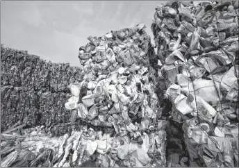  ??  ?? Plastic trash is compacted into bales for further processing at the waste processing dump on the outskirts of Minsk, Belarus. Dozens of Canadian environmen­t groups say if Canada wants to be a leader in getting the rest of the world to kick its plastics...